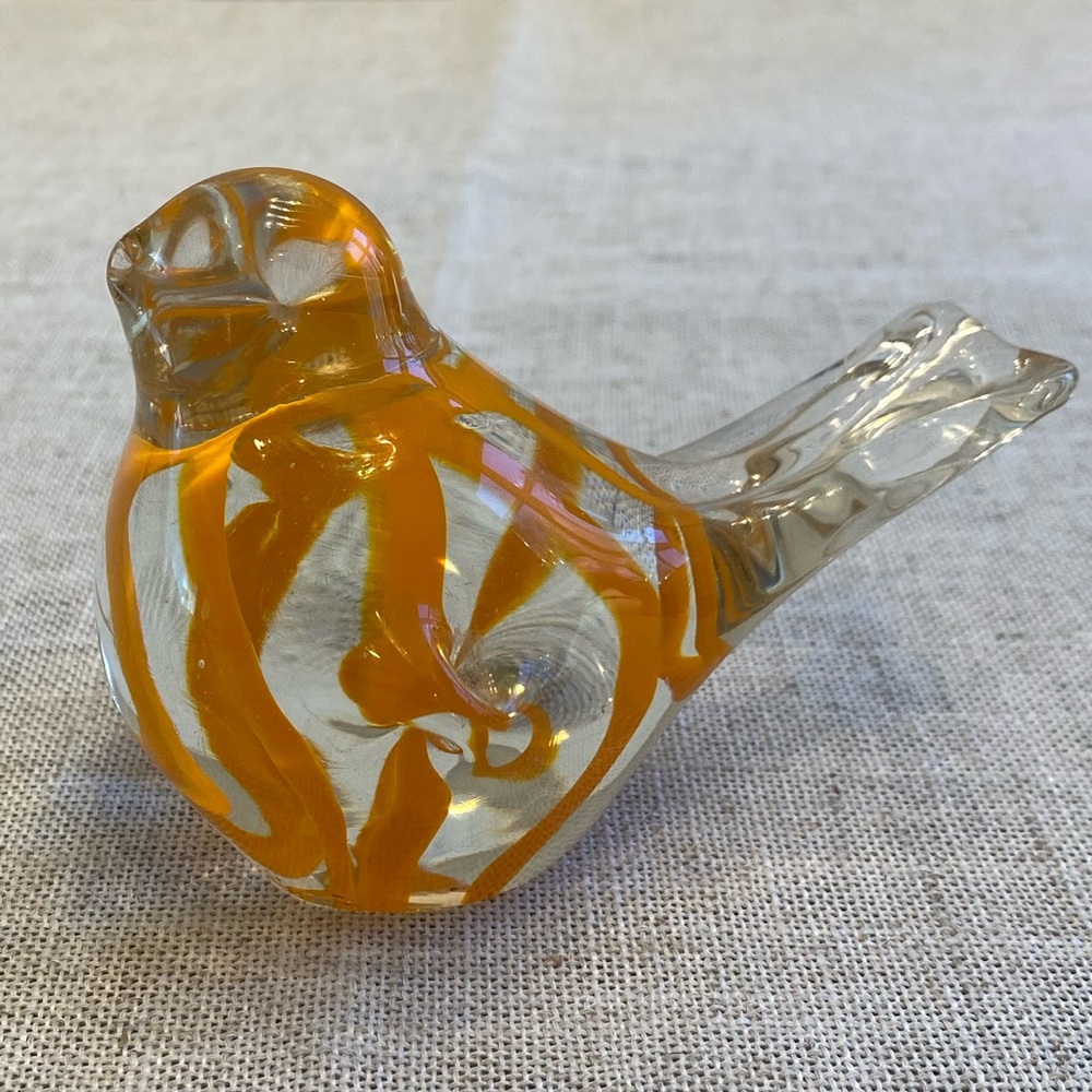 Art glass bird with orange coloring.